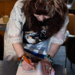 Author Krisine Johnson autographing a book.